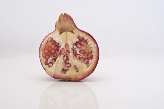 Ripe pomegranate fruit isolated on white background