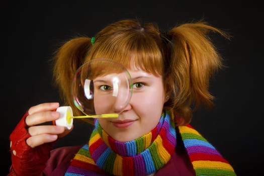 girl with soap bubbles on a black background