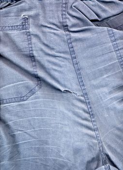blue trousers used and torn on the back