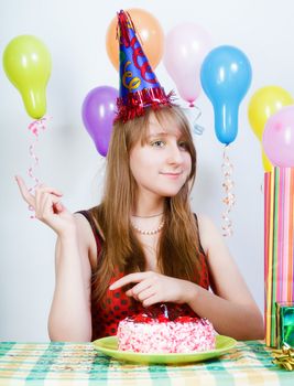 Happy birthday. Attractive young girl dancing at the table