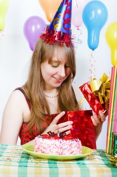 Birthday of a young girl. Opening the gifts
