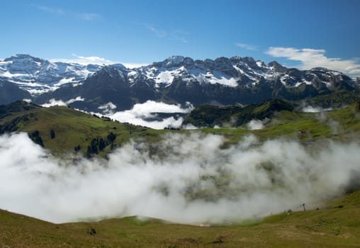 morning mist covers the meadows of the Swiss Alps