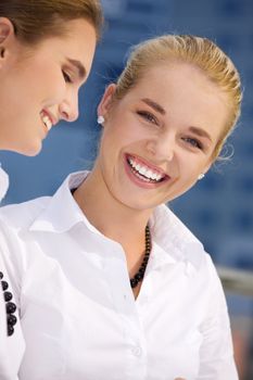 picture of two happy businesswomen (focus on blonde)