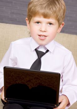 picture of happy boy with black laptop computer