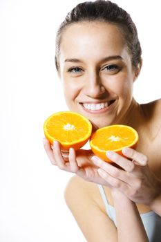 Beauty shot of a young woman with orange half on white background