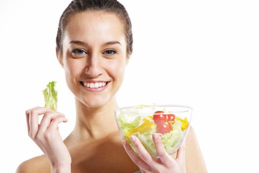 girl holding plate with salad on white background