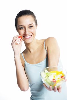 girl holding plate with salad on white background