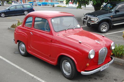 Red retro car at parking, New Zealand