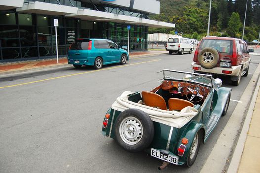 Green retro car at parking, New Zealand