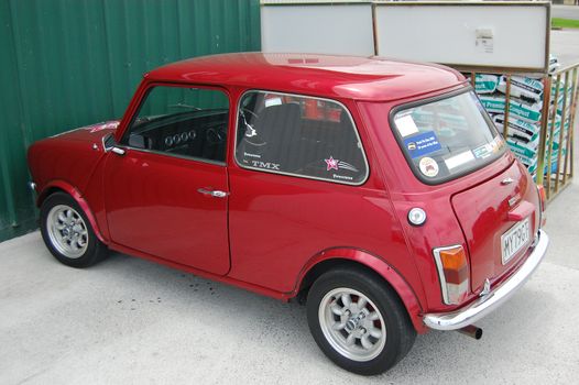 Red retro car at parking, New Zealand