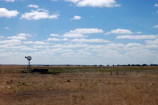 Windmill. Driving on the highway in Australian outback