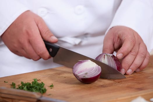 Chef chopping a red onion