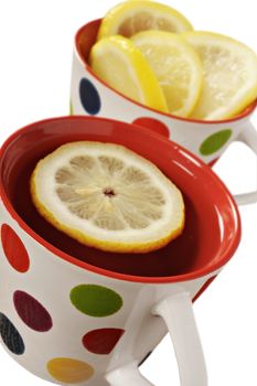 Healthy herbal tea with lemon in polka dot cups