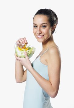 girl holding plate with salad on white background