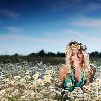 beautiful girl on the daisy flowers field 