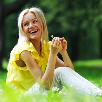 woman dachshund in her arms on grass