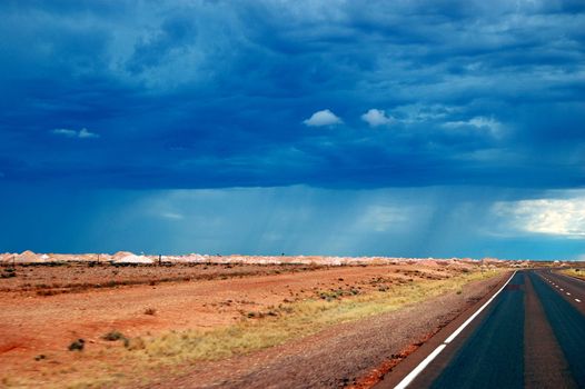 Cloudy sky over highway, Coober Pedy, Northenr Territory, Australia