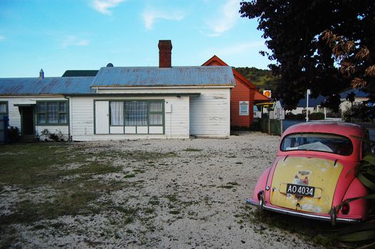 Retro car at backyard of the house, Banks Peninsula, Akaroa, New Zealand