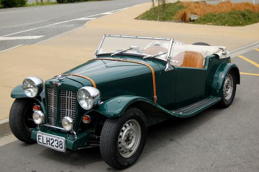 Dark green retro car in the town street, Picton, New Zealand