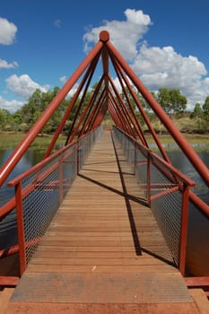 Red timber/metal bridge over the river, Northern Territory, Australia