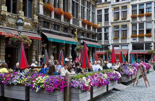 BRUSSELS - JULY 2 : Unidentified people seat in a cafe at Grand place Brussels , Belgium on July 2 2011 , Grand place is "Unesco world heritage" site since 1998.  