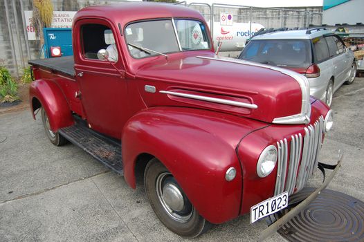 Red retro car at the parking area, New Zealand