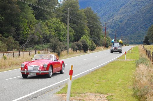 Red retro car at the highway, New Zealand