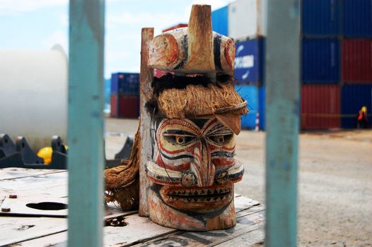 Timber mask in Port Moresby port, industrial area of the city, Papua New Guinea