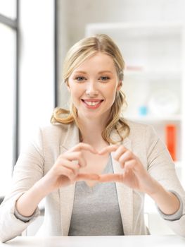 bright picture of young woman showing heart sign