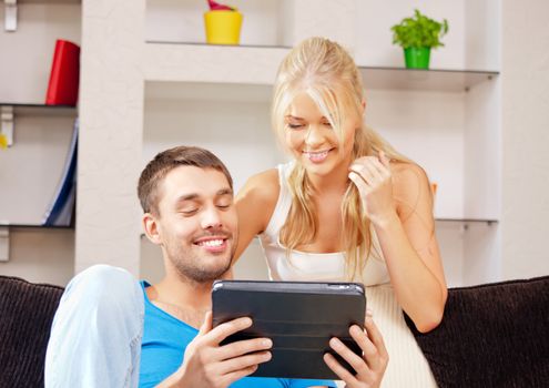 bright picture of happy couple with tablet PC (focus on man)