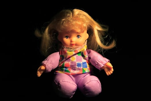 Doll on black background