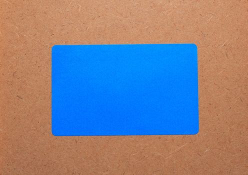 Blue paper on a wooden background.Note paper.