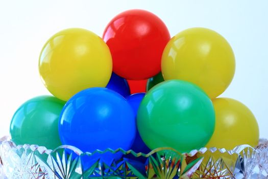 Balls color  in a vase on a white background