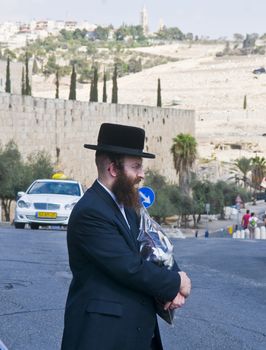 JERUSALEM - OCTOBER 06 2011 : An ultra- Orthodox Jewish man stand near the walls of old  Jerusalem , Israel