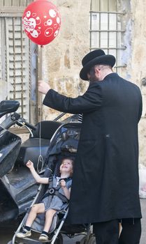 JERUSALEM - OCTOBER 10 2011 : Jewish ultra family in the " Mea Shearim" neighborhood in Jerusalem Israel.