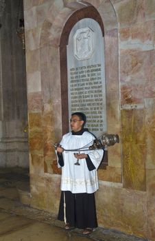 JERUSALEM - NOVEMBER 03 2011 - Thurible held by altar server in the church of the holy sepulcher in Jrusalem Israel 