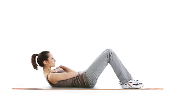 Fitness woman doing fitness exercise on mat . White background