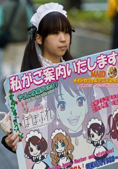 KYOTO , JAPAN - OCT 29 : Japanese girl dressed as a maid promoting "Maid cafe" in Tokyo Japan on October 29 2009 , In Maid cafes the waitresses dressed in maid costumes and act as servants , these cafes are very popular in Japan 