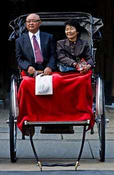 TOKYO - OCT 29 : Japanese couple seat on a trditional rickshaw on October 29 2009 in Tokyo , Japan