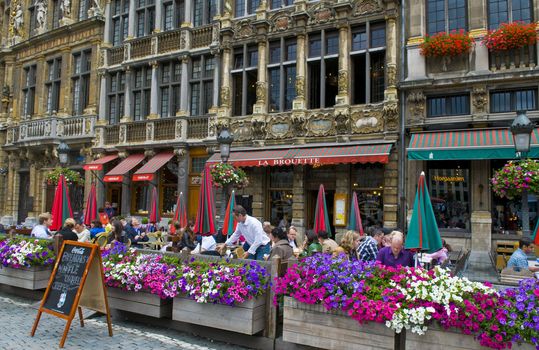 BRUSSELS - JULY 2 : Unidentified people seat in a cafe at Grand place Brussels , Belgium on July 2 2011 , Grand place is "Unesco world heritage" site since 1998.  