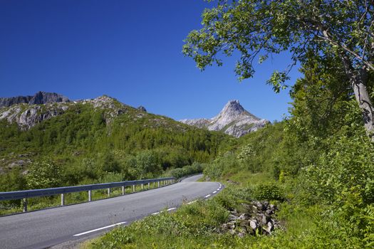 Picturesque road across Lofoten islands in arctic Norway, popular destination of many european roadtrips