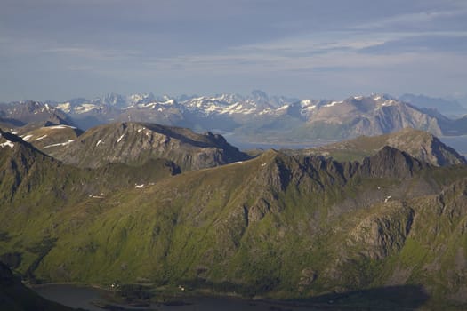 Panoramic view of tallest mountain peaks on Lofoten islands in Norway from Justadtinden