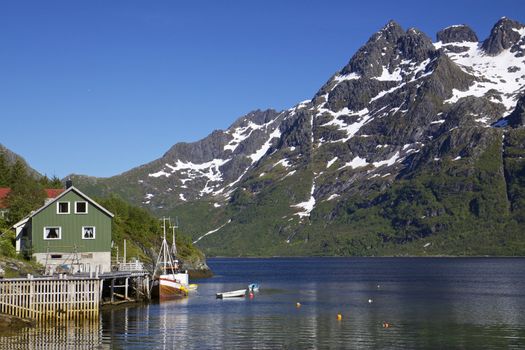 Scenic norwegian fjord on Lofoten islands with traditional fishing boat
