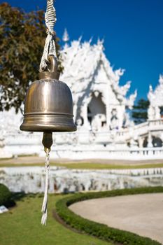 Bell in white temple Wat Rong Khun. Wat Rong Khun is a contemporary unconventional Buddhist temple in Chiang Rai, Chiangmai province, Thailand. It is designed in white color.
