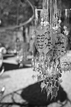Traditional buddhist hanging decorations with bells and handwriting wishes, prayer words