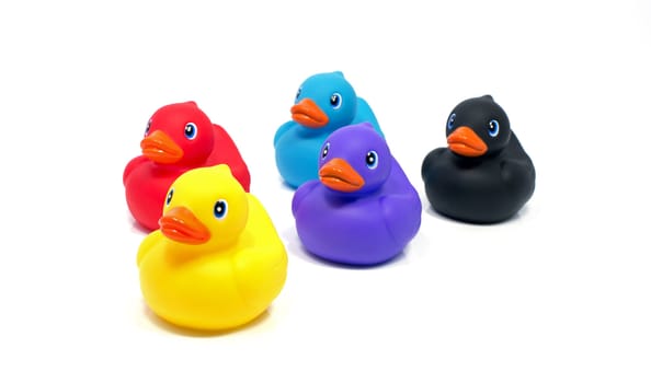 red yellow blue pink and black bath ducks isolated on white