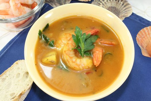 a bowl of bouillabaisse with shrimp and mussels