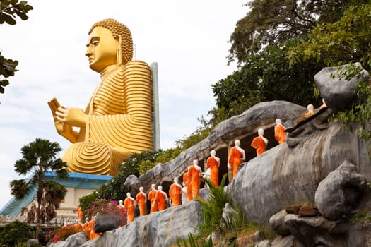 golden seated buddha in dambulla, sri lanka