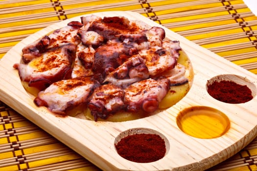 Octopus with paprika, potatoes and olive oil typical of Galicia, Spain