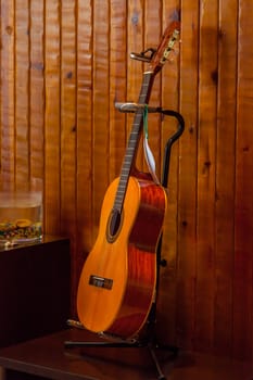 Classic spanish guitar  near of a wood wall